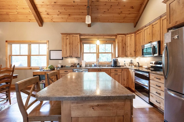 kitchen with sink, wood ceiling, vaulted ceiling with beams, and appliances with stainless steel finishes