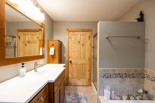 bathroom with vanity and shower with separate bathtub