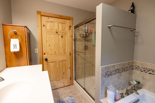 bathroom featuring sink, tile patterned floors, and a shower with shower door