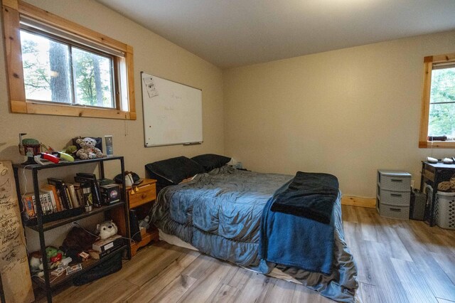 bedroom with hardwood / wood-style flooring