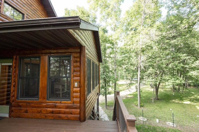 wooden terrace featuring a yard