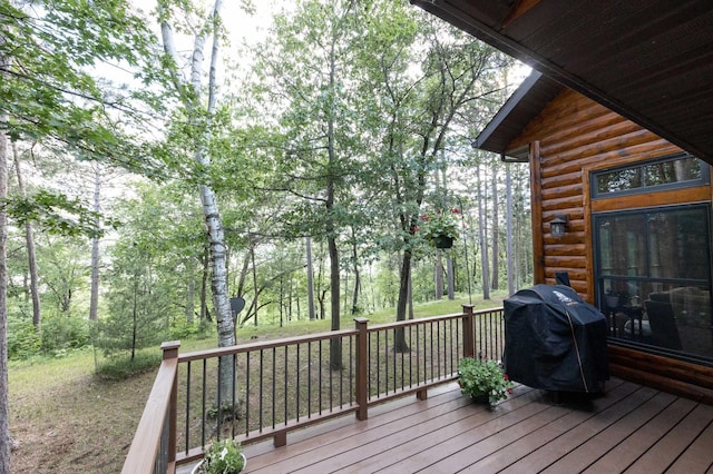 wooden deck with a grill