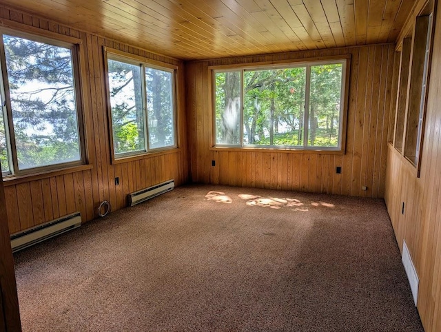 unfurnished sunroom with a baseboard radiator, a wealth of natural light, and wooden ceiling