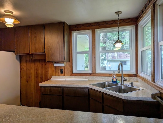 kitchen featuring sink, decorative light fixtures, and white fridge