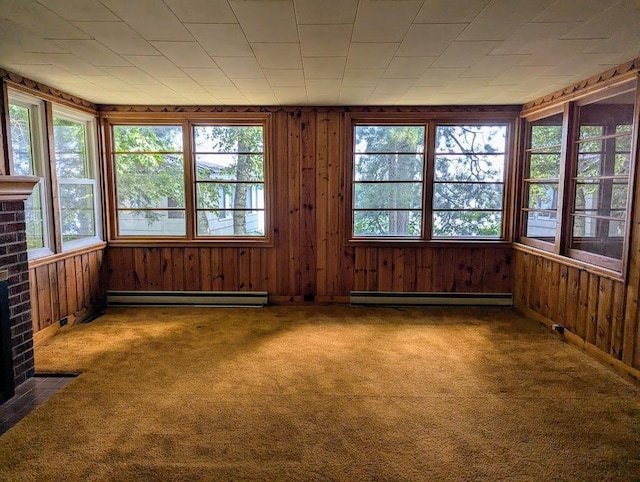 unfurnished sunroom featuring a baseboard radiator and plenty of natural light