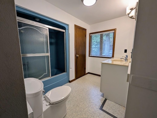 full bathroom with vanity, shower / bath combination with glass door, and toilet