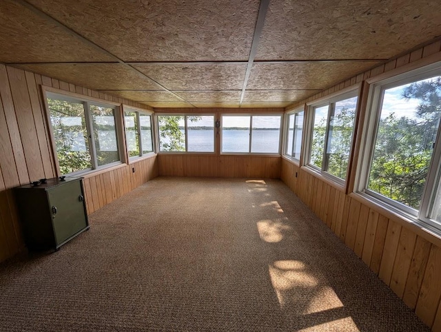 unfurnished sunroom with plenty of natural light and a water view