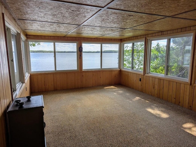 unfurnished sunroom with a water view and a wealth of natural light