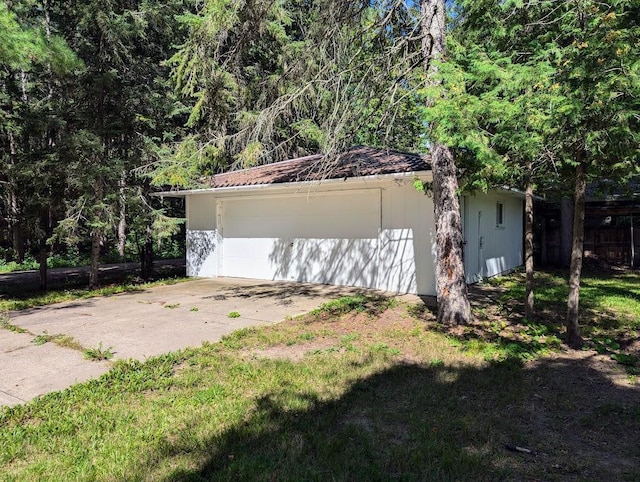 view of property exterior featuring a garage and an outdoor structure