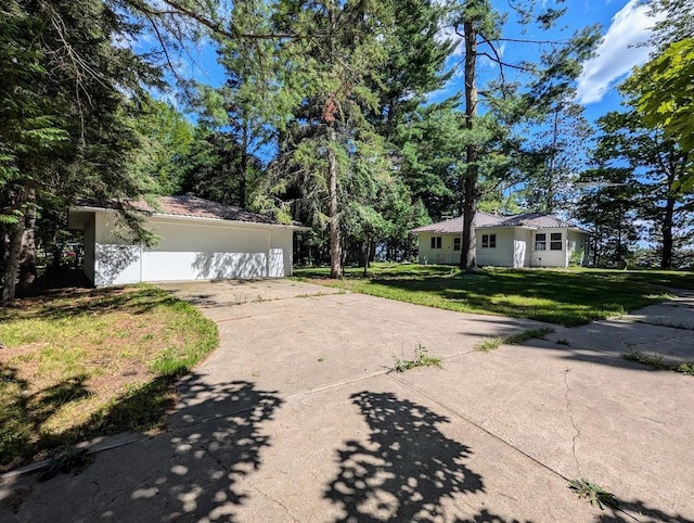 exterior space featuring a garage and a front yard