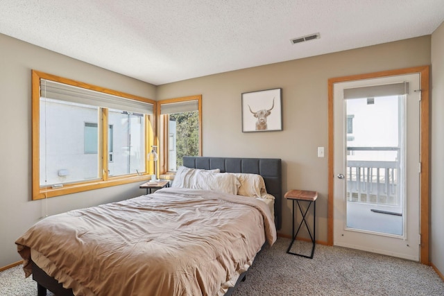 bedroom with carpet flooring and a textured ceiling