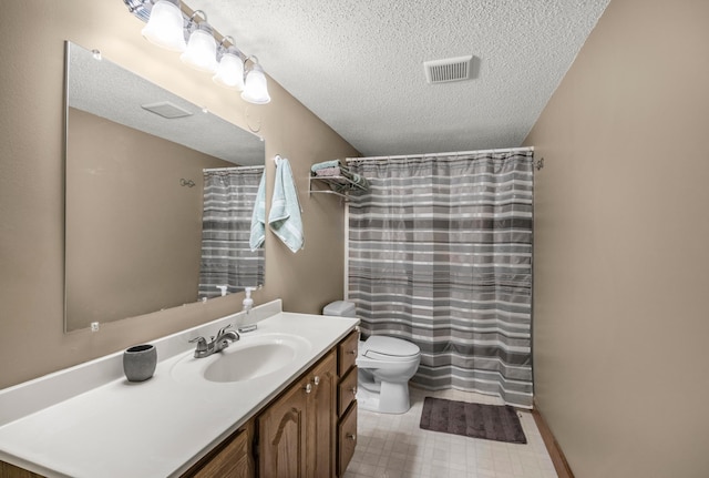 bathroom featuring vanity, toilet, and a textured ceiling