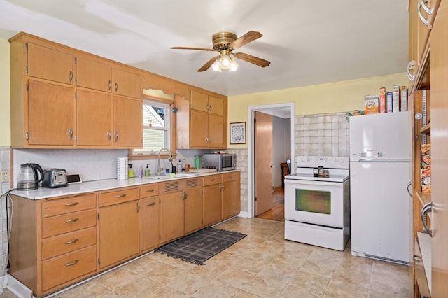 kitchen featuring ceiling fan, sink, backsplash, and white appliances