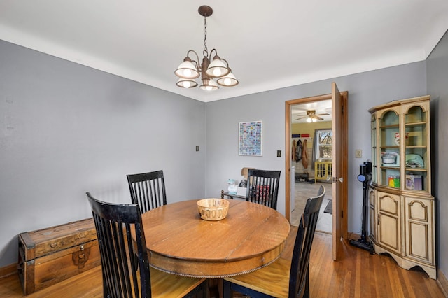 dining room featuring hardwood / wood-style flooring and a chandelier