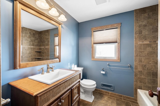 bathroom featuring tile patterned flooring, toilet, visible vents, vanity, and baseboards