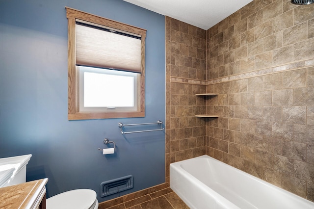 bathroom featuring visible vents, toilet, tile patterned flooring, tub / shower combination, and vanity