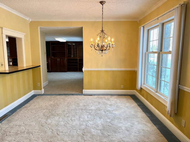 unfurnished dining area with an inviting chandelier, ornamental molding, carpet, and a textured ceiling