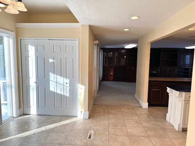 tiled entryway with a textured ceiling