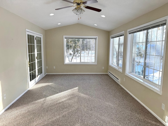 carpeted spare room with lofted ceiling, a baseboard heating unit, a textured ceiling, and ceiling fan