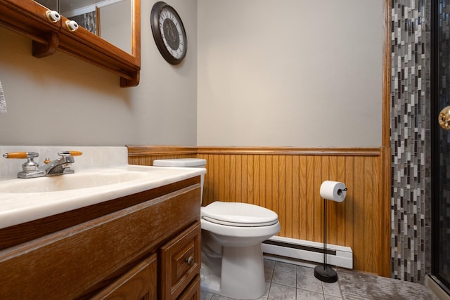 bathroom with baseboard heating, vanity, a shower, tile patterned floors, and toilet