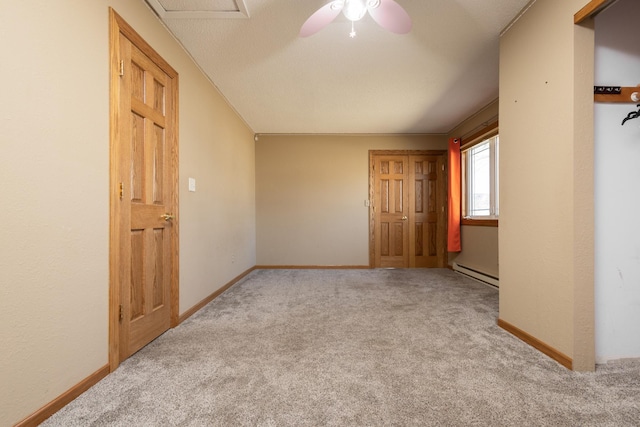 empty room featuring baseboard heating, light colored carpet, and ceiling fan