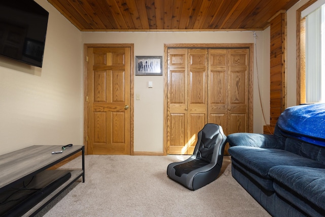 living area featuring light colored carpet and wooden ceiling