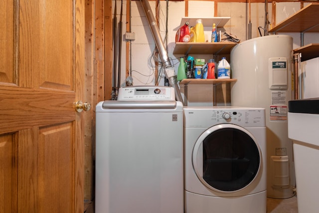 washroom featuring electric water heater and washer and dryer