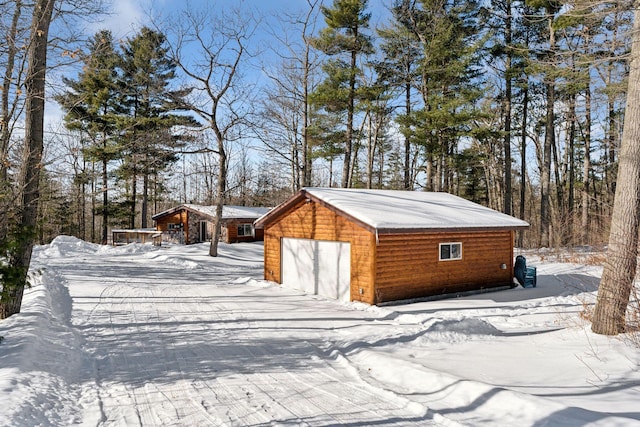 snow covered structure featuring an outdoor structure