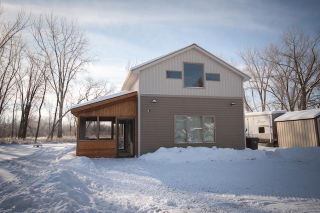 view of snow covered rear of property