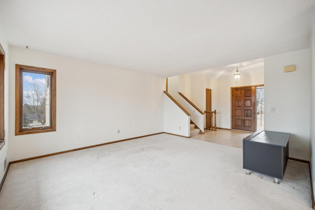 unfurnished living room featuring carpet