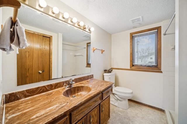 bathroom with vanity, toilet, a textured ceiling, and walk in shower