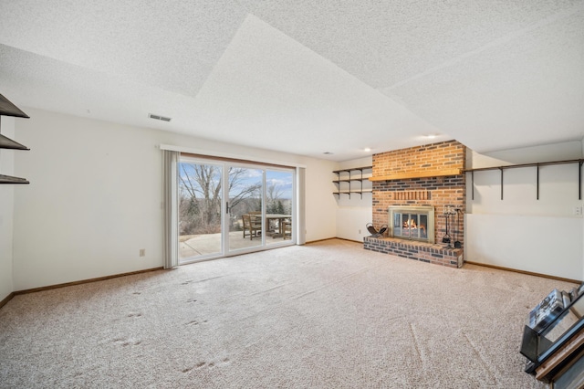 unfurnished living room with carpet, a textured ceiling, and a fireplace