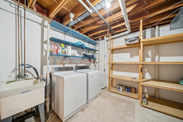 clothes washing area with sink and washing machine and dryer