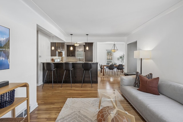 living room featuring baseboards and wood finished floors