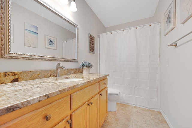 bathroom featuring vanity, tile patterned floors, and toilet