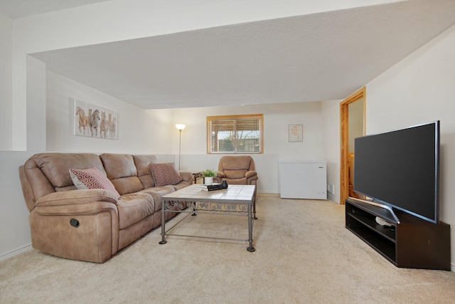 living room featuring carpet flooring and a textured ceiling