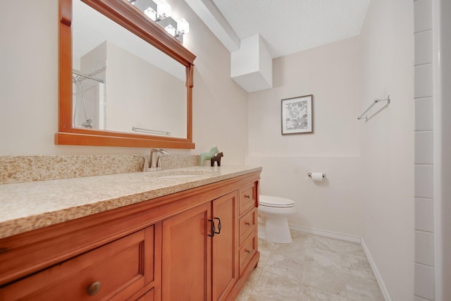 bathroom with vanity, toilet, a textured ceiling, and walk in shower