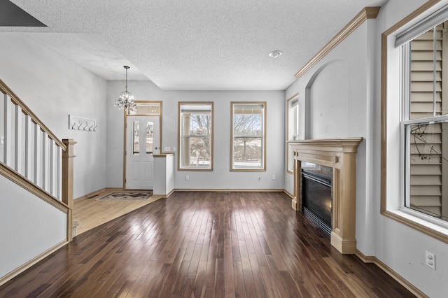 interior space with dark hardwood / wood-style flooring, a chandelier, and a textured ceiling