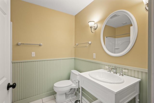 bathroom featuring tile patterned flooring, vanity, a shower, and toilet