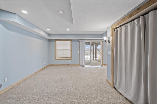 carpeted spare room featuring a textured ceiling