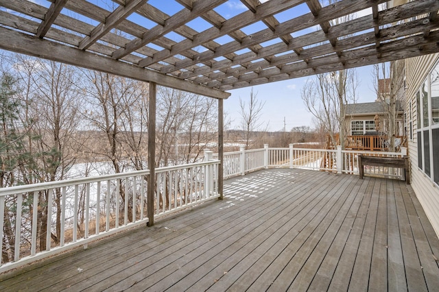 snow covered deck with a pergola