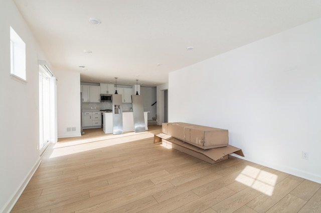 unfurnished living room featuring light wood-type flooring