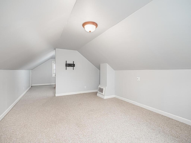 additional living space with lofted ceiling and carpet flooring