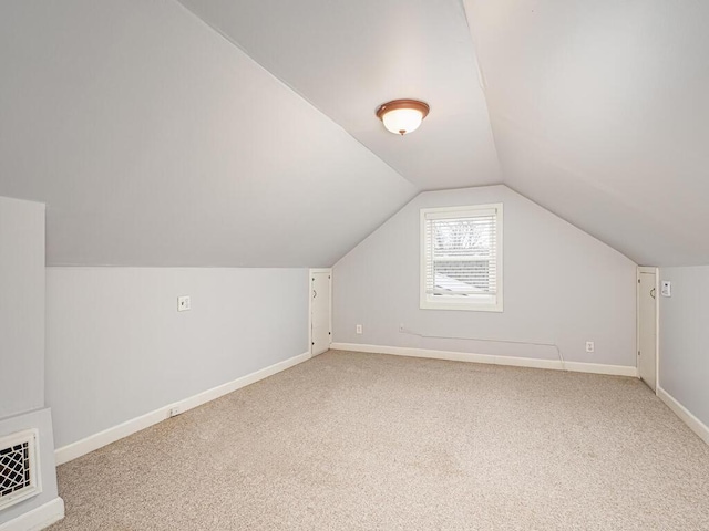 bonus room featuring vaulted ceiling and carpet flooring