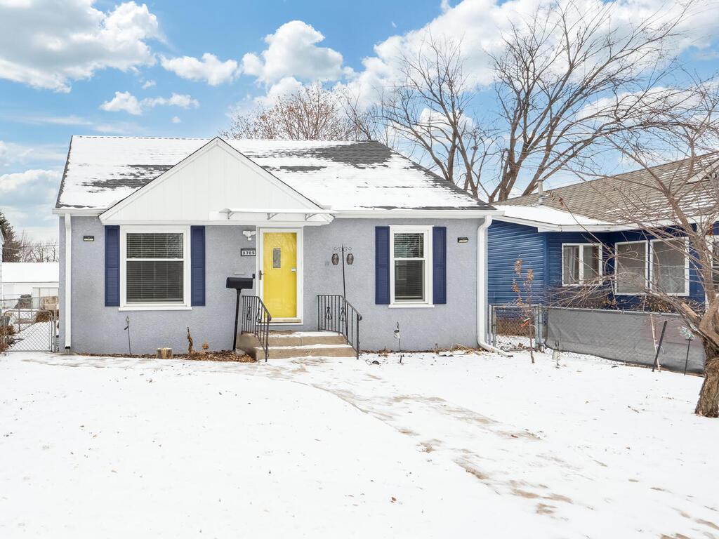 bungalow-style house with fence and stucco siding