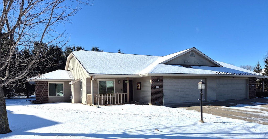 ranch-style house with a garage and covered porch