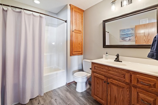 full bathroom with toilet, shower / bath combination with curtain, wood finished floors, and vanity