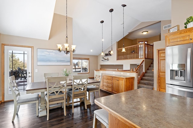 kitchen with hanging light fixtures, dark wood-style flooring, a wealth of natural light, and stainless steel fridge with ice dispenser