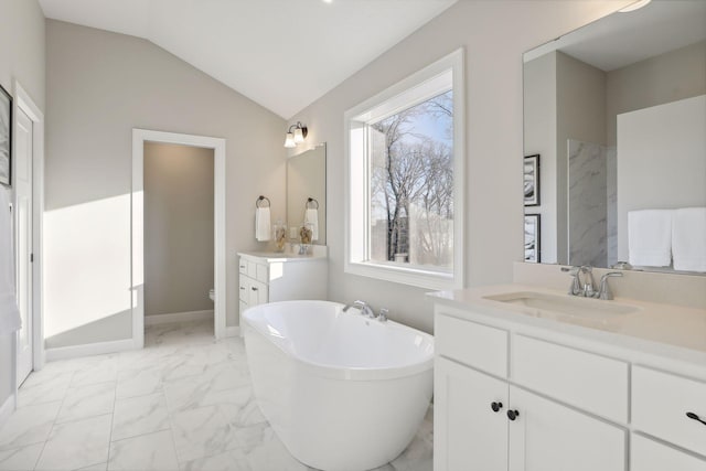 bathroom with a bath, vaulted ceiling, toilet, and vanity