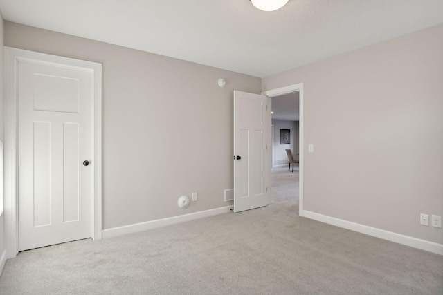 unfurnished bedroom featuring light colored carpet